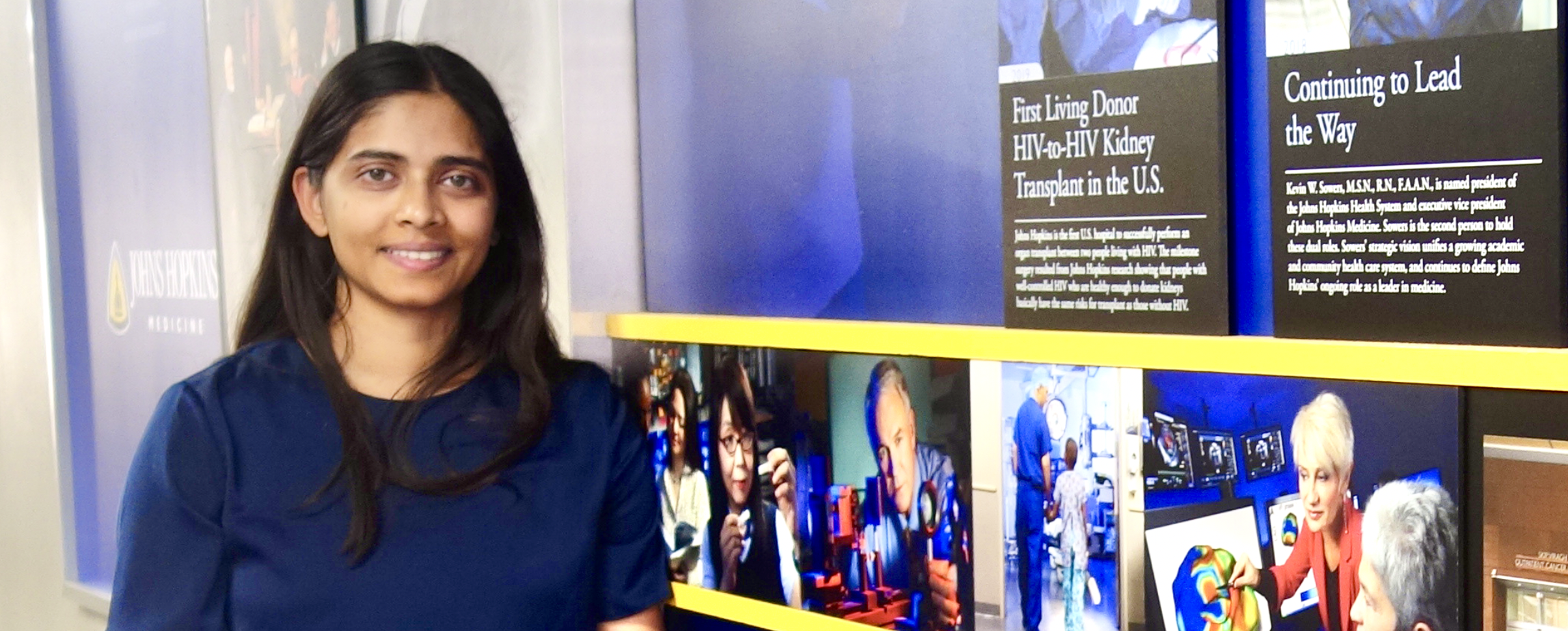Ananya A. Joshi at the Johns Hopkins historical timeline wall
